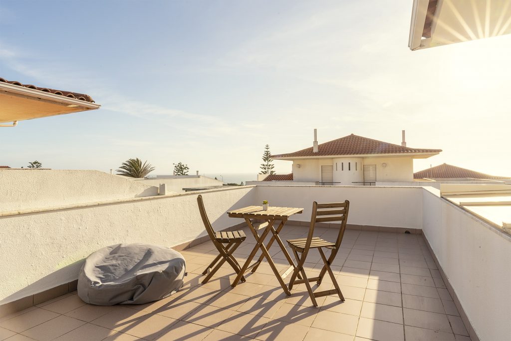 Sunny terrace and outdoor space at Wooden accents and neat, bright twin beds at Ericeira Paradise Guest House and Suites
