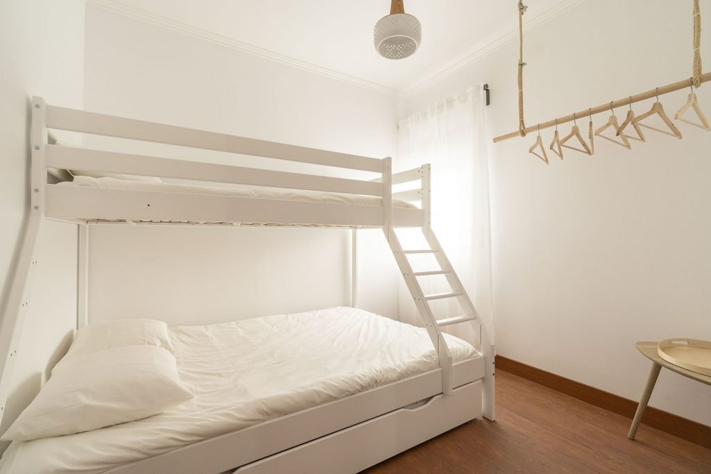 Clean, bright bunk bed room perfect for families. There is a double bed and a single bed on the second bunk